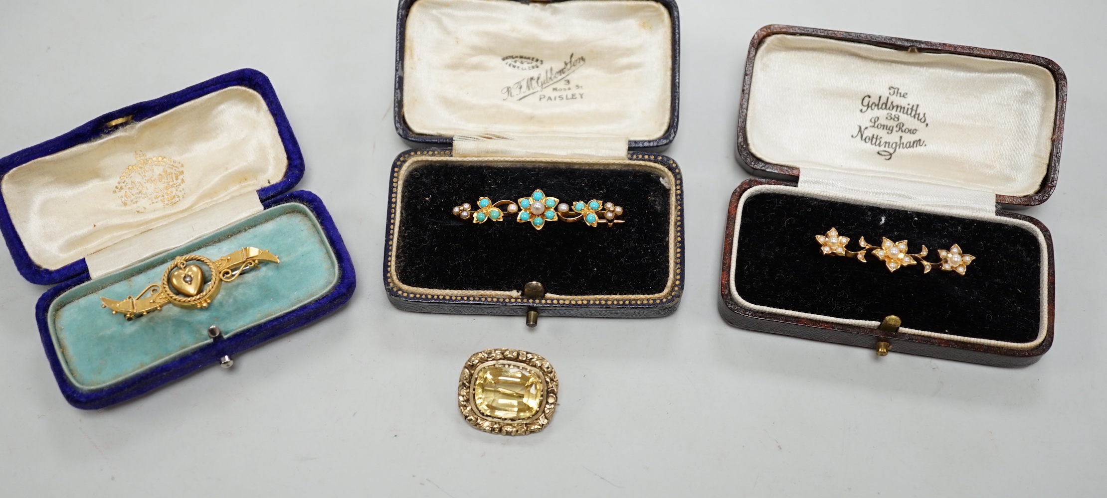 An Edwardian 15ct gold and seed peal set heart drop bar brooch, 40mm, gross weight 2.7 grams, two other yellow metal and gem set bar brooches and a Victorian citrine set brooch.